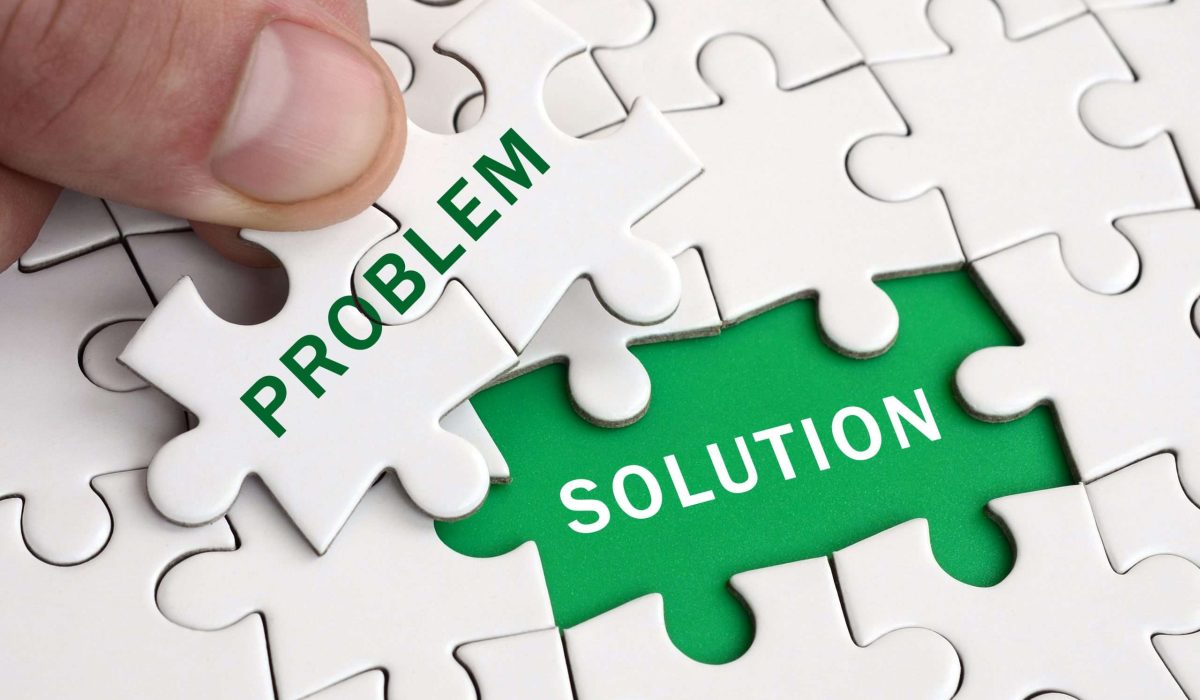 The human hand fills the last missing elements of the surface from the jigsaw puzzle. Image with words problem and solution